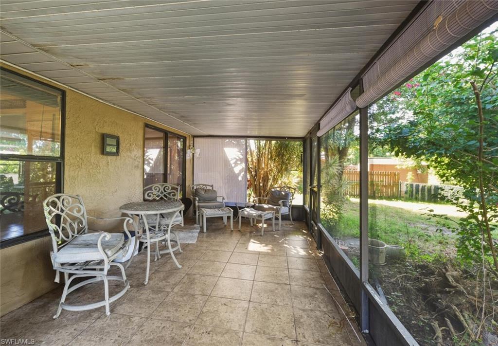 2747 47th Street Southwest Naples, FL 34116 - Photo 19 of 21 a view of a porch with chairs and backyard