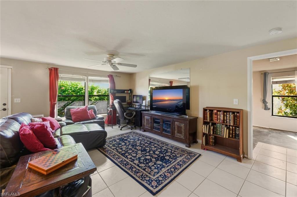 2747 47th Street Southwest Naples, FL 34116 - Photo 4 of 21 a living room with furniture and a flat screen tv
