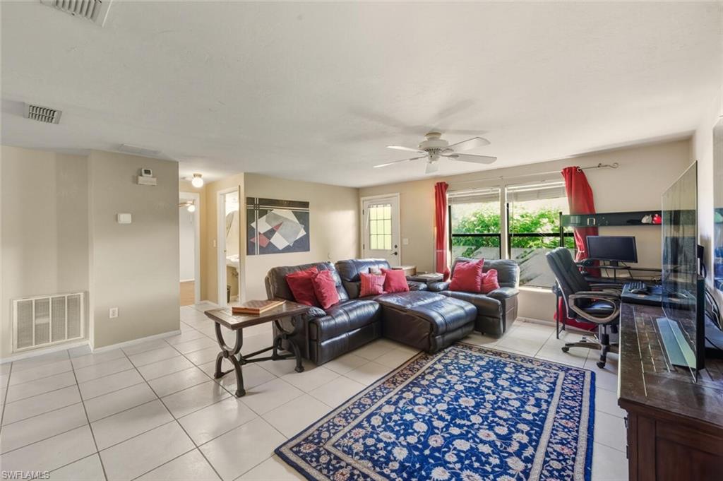 2747 47th Street Southwest Naples, FL 34116 - Photo 5 of 21 a living room with furniture and a window