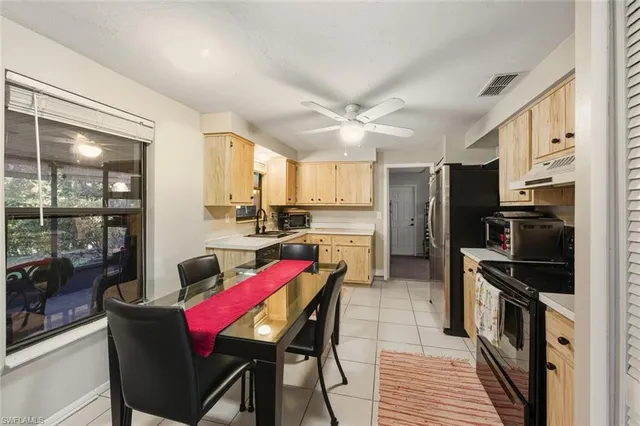 a kitchen with a sink cabinets and window