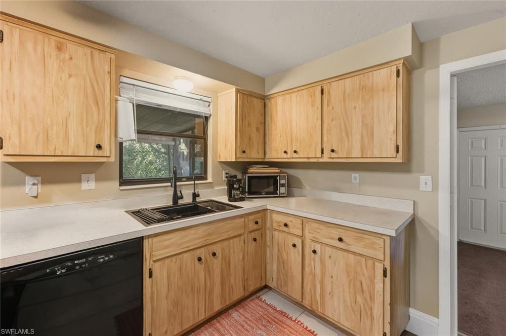 2747 47th Street Southwest Naples, FL 34116 - Photo 8 of 21 a kitchen with a sink cabinets and window