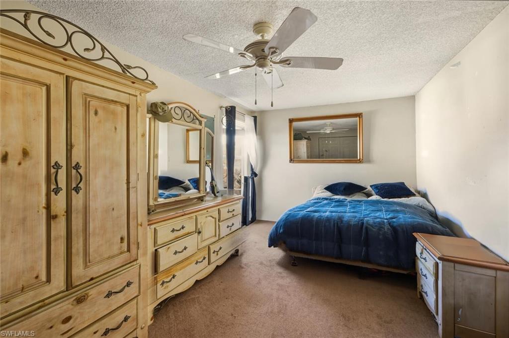 2747 47th Street Southwest Naples, FL 34116 - Photo 10 of 21 a bedroom with a bed and a view of bathroom