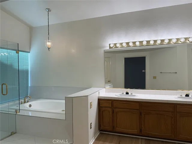 a bathroom with a double vanity sink and mirror
