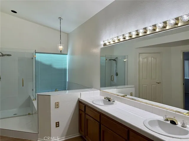a bathroom with a double vanity sink and mirror