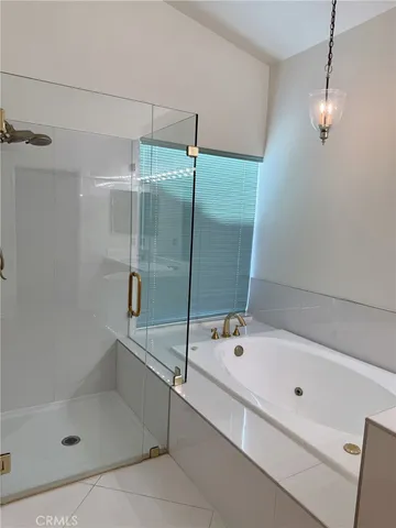 a bathroom with a shower and a bath tub