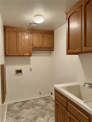 a view of a storage and utility room with wooden floor