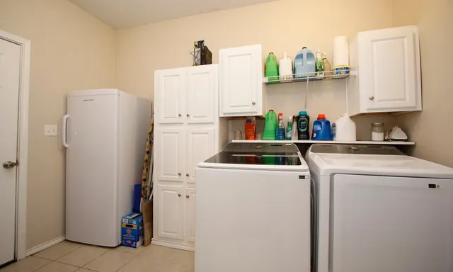 a view of storage and utility room with washer and dryer