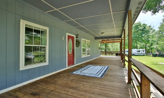 a view of outdoor space with wooden floor and windows