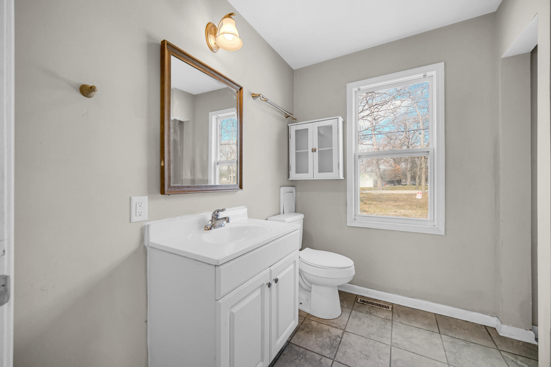 6415 West 146th Place Crown Point, IN 46307 - Photo 14 of 23 a bathroom with a toilet sink and mirror