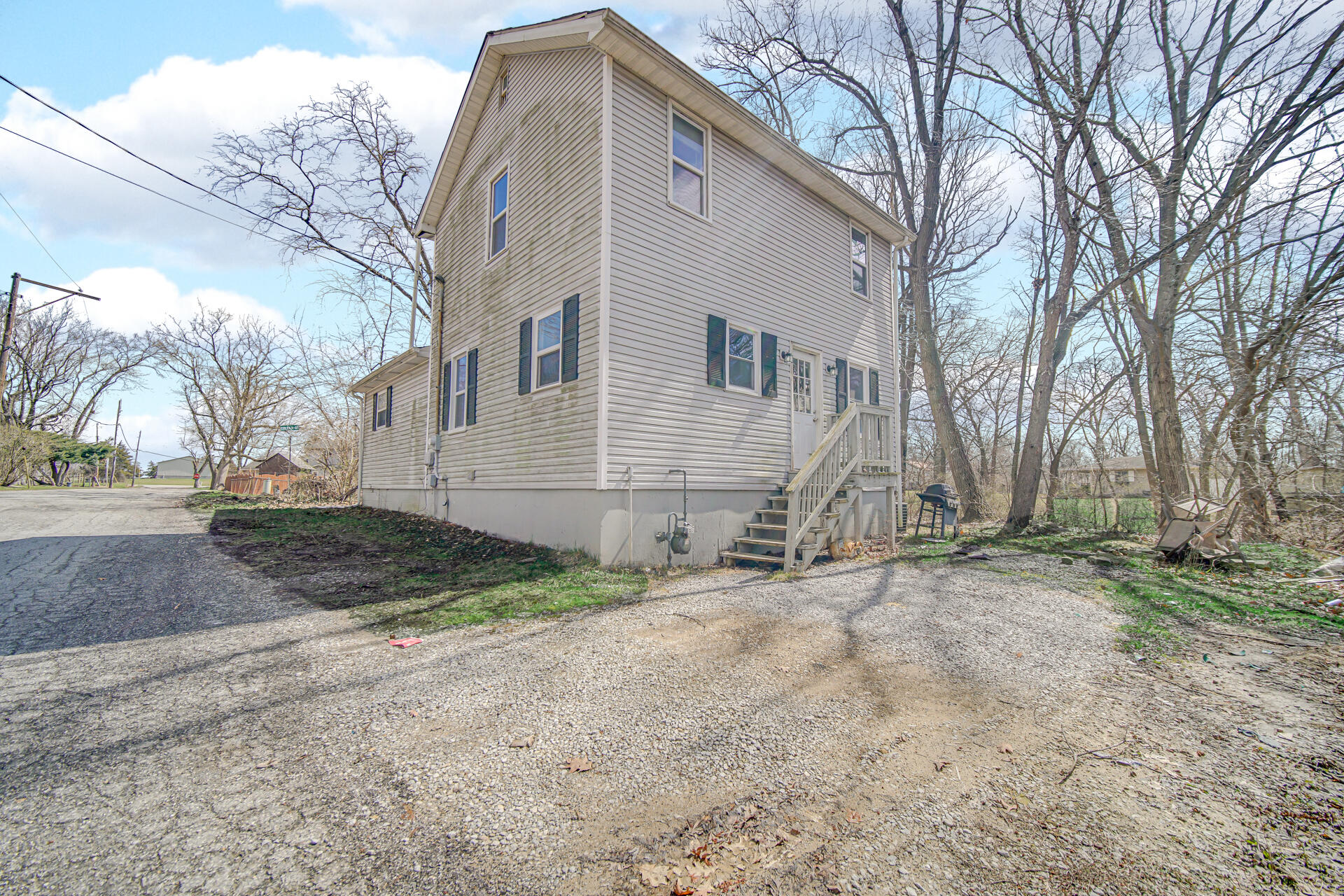 6415 West 146th Place Crown Point, IN 46307 - Photo 3 of 23 a view of a white house with a yard
