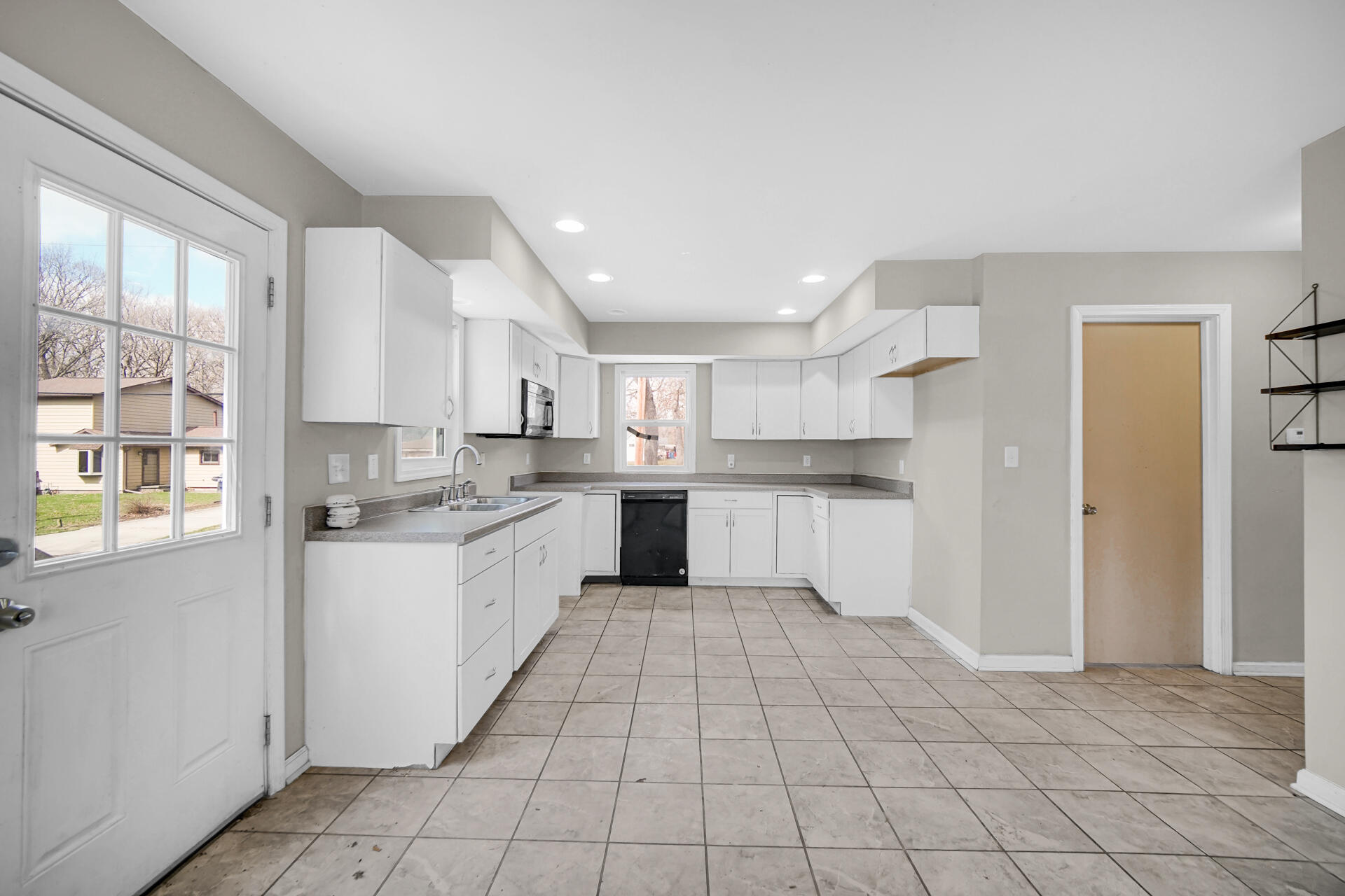 6415 West 146th Place Crown Point, IN 46307 - Photo 8 of 23 a large kitchen with a white stove top oven and white cabinets