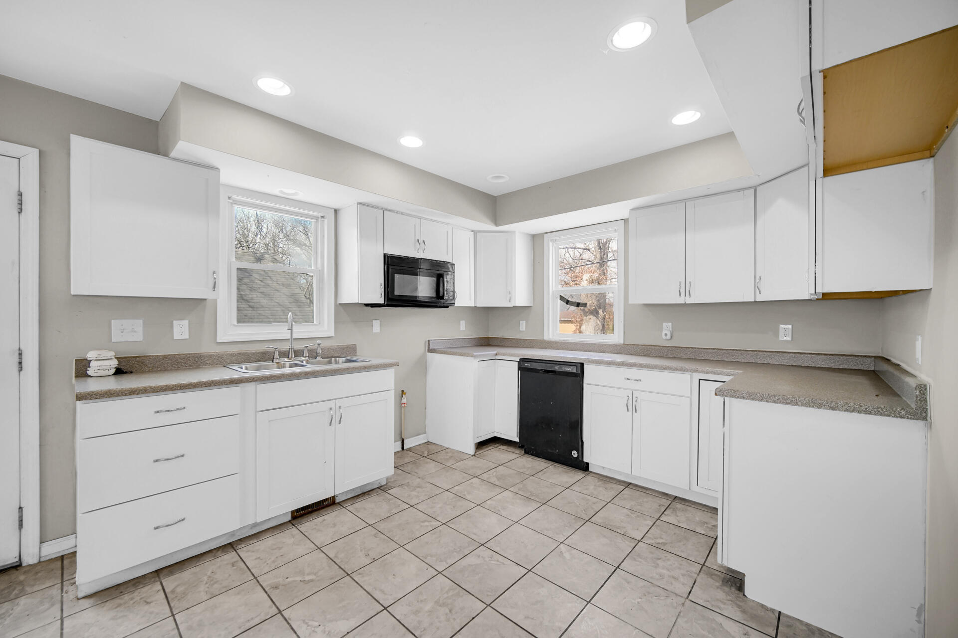 6415 West 146th Place Crown Point, IN 46307 - Photo 9 of 23 a kitchen with granite countertop white cabinets white stainless steel appliances with a sink and dishwasher