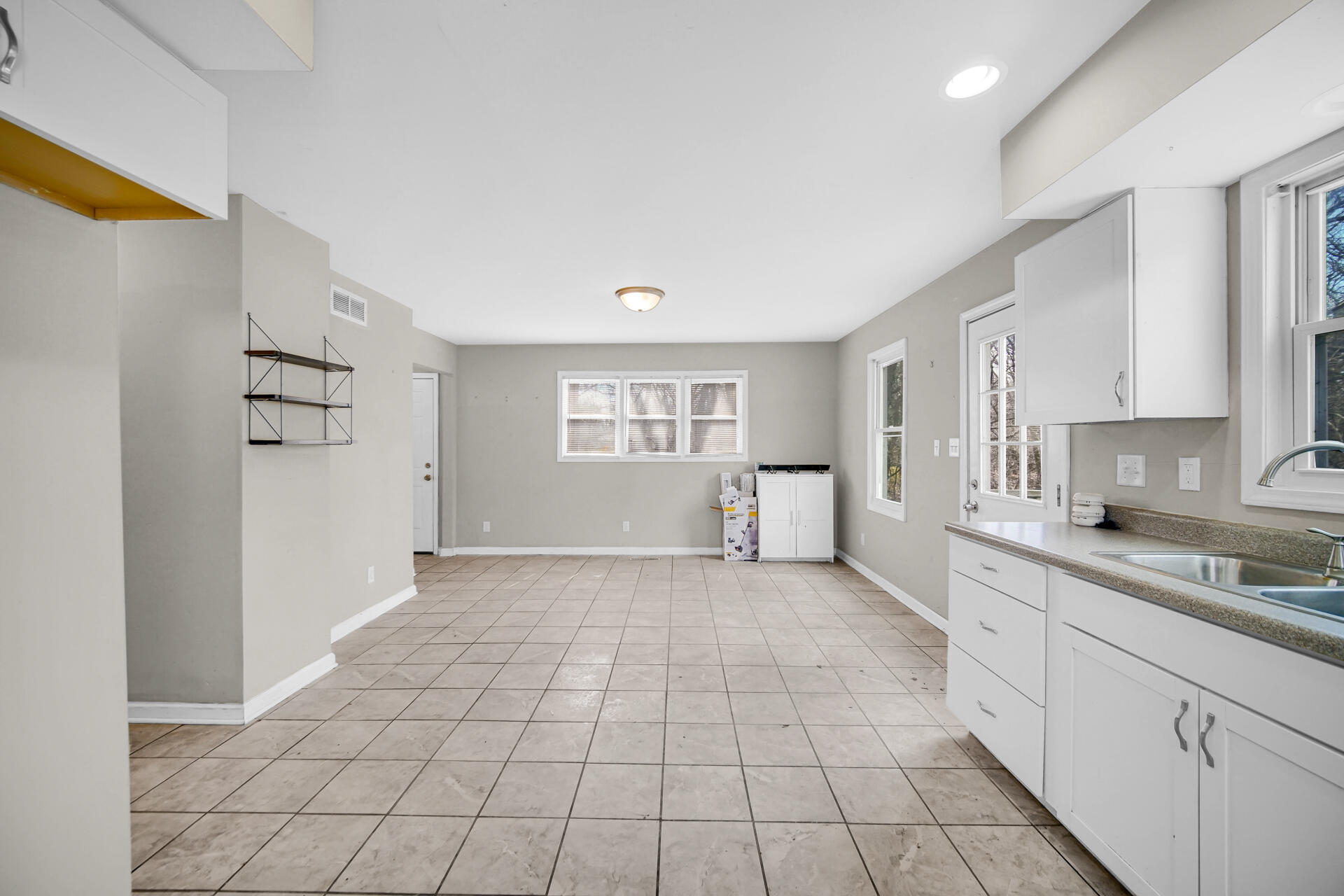 6415 West 146th Place Crown Point, IN 46307 - Photo 10 of 23 a large white kitchen with white cabinets and a sink
