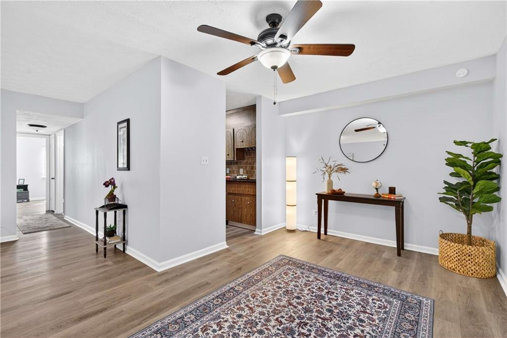 2396 Lawrenceville Highway, Unit G Decatur, GA 30033 - Photo 12 of 30 a view of a hallway with wooden floor and furniture