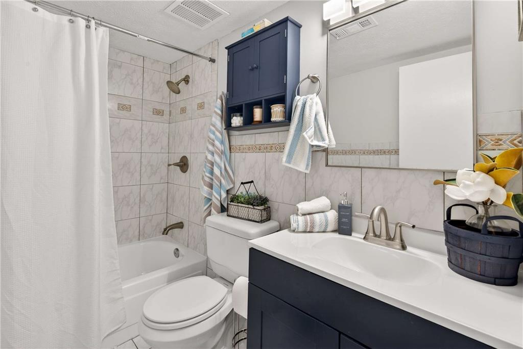 2396 Lawrenceville Highway, Unit G Decatur, GA 30033 - Photo 19 of 30 a bathroom with a sink a toilet and shower