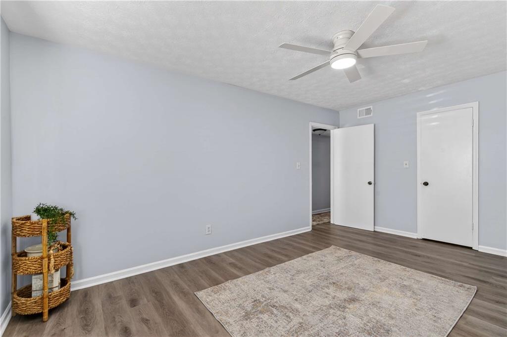 2396 Lawrenceville Highway, Unit G Decatur, GA 30033 - Photo 22 of 30 an empty room with a window and ceiling fan