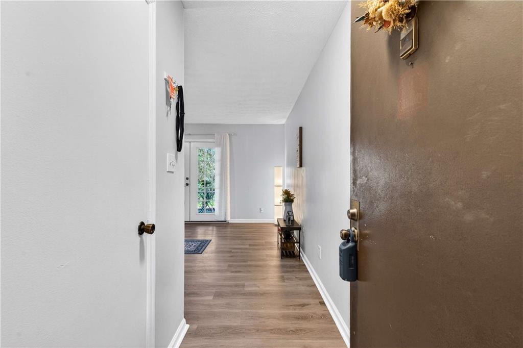 2396 Lawrenceville Highway, Unit G Decatur, GA 30033 - Photo 3 of 30 a view of a hallway with wooden floor and staircase