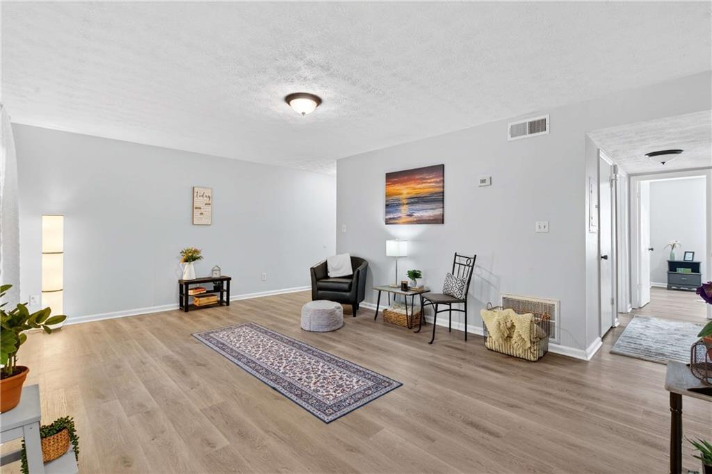 2396 Lawrenceville Highway, Unit G Decatur, GA 30033 - Photo 7 of 30 a living room with furniture and a wooden floor