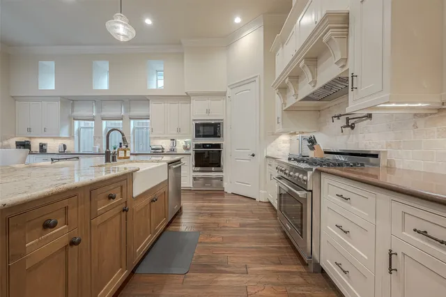 a kitchen with stainless steel appliances granite countertop a sink and cabinets