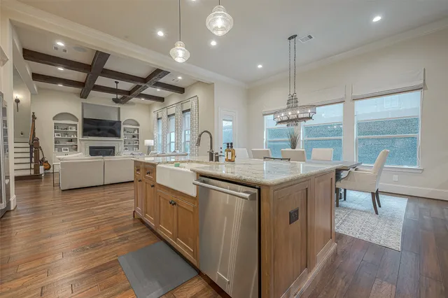 a kitchen with sink stove and wooden floor