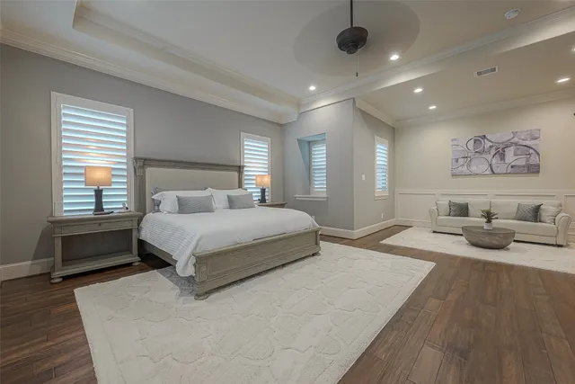 a spacious bedroom with a large bed and a couch