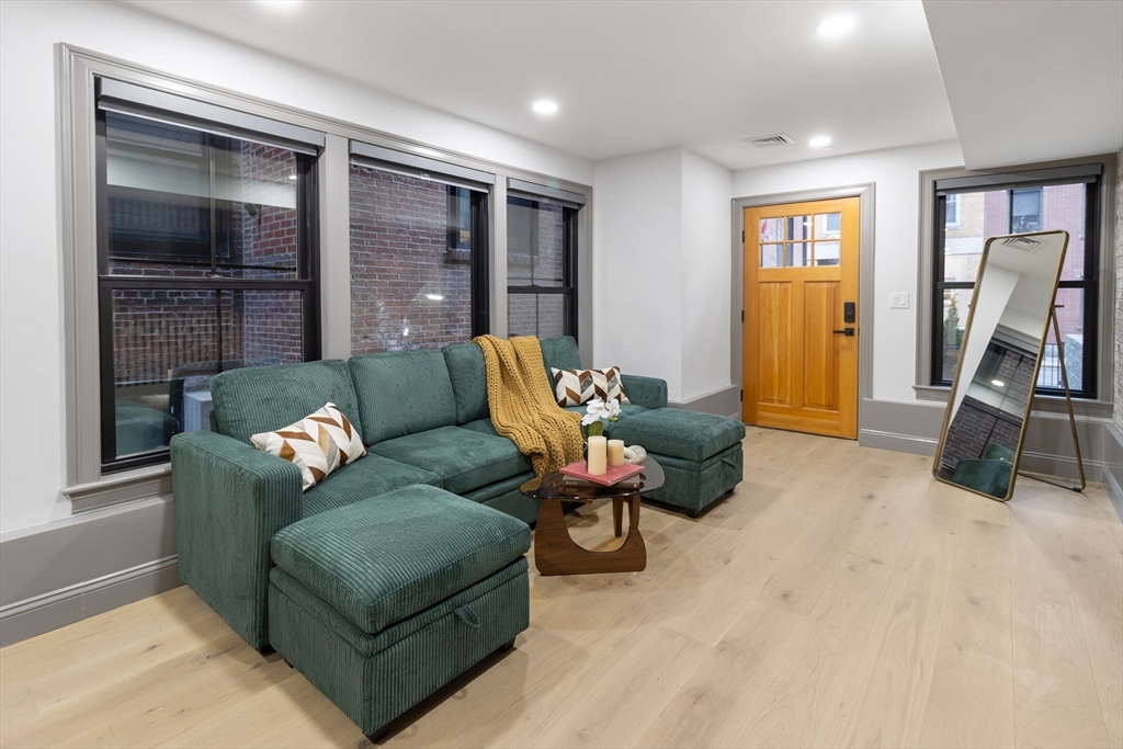 4 Snelling Place, Unit 4 Boston, MA 02113 - Photo 1 of 15 a living room with furniture gym equipment and a flat screen tv