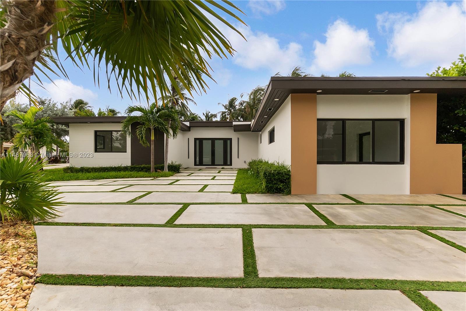 a front view of a house with a garden