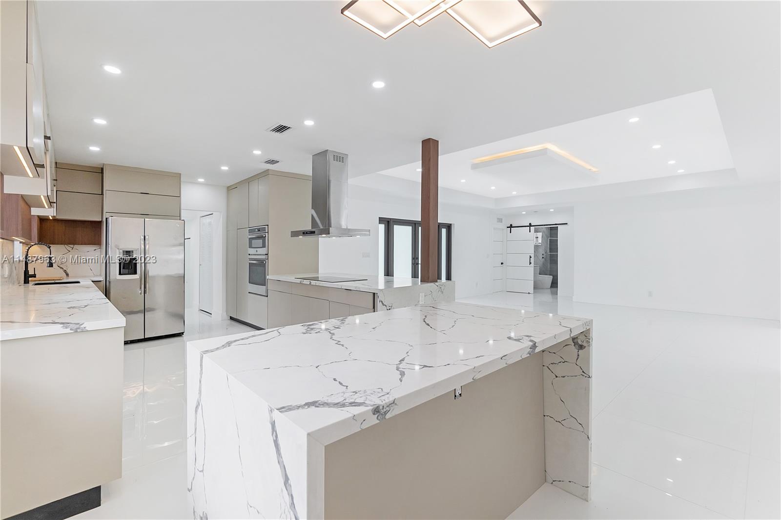 1200 Cleveland Road Miami Beach, FL 33141 - Photo 11 of 41 a kitchen with stainless steel appliances kitchen island a white counter space and a sink