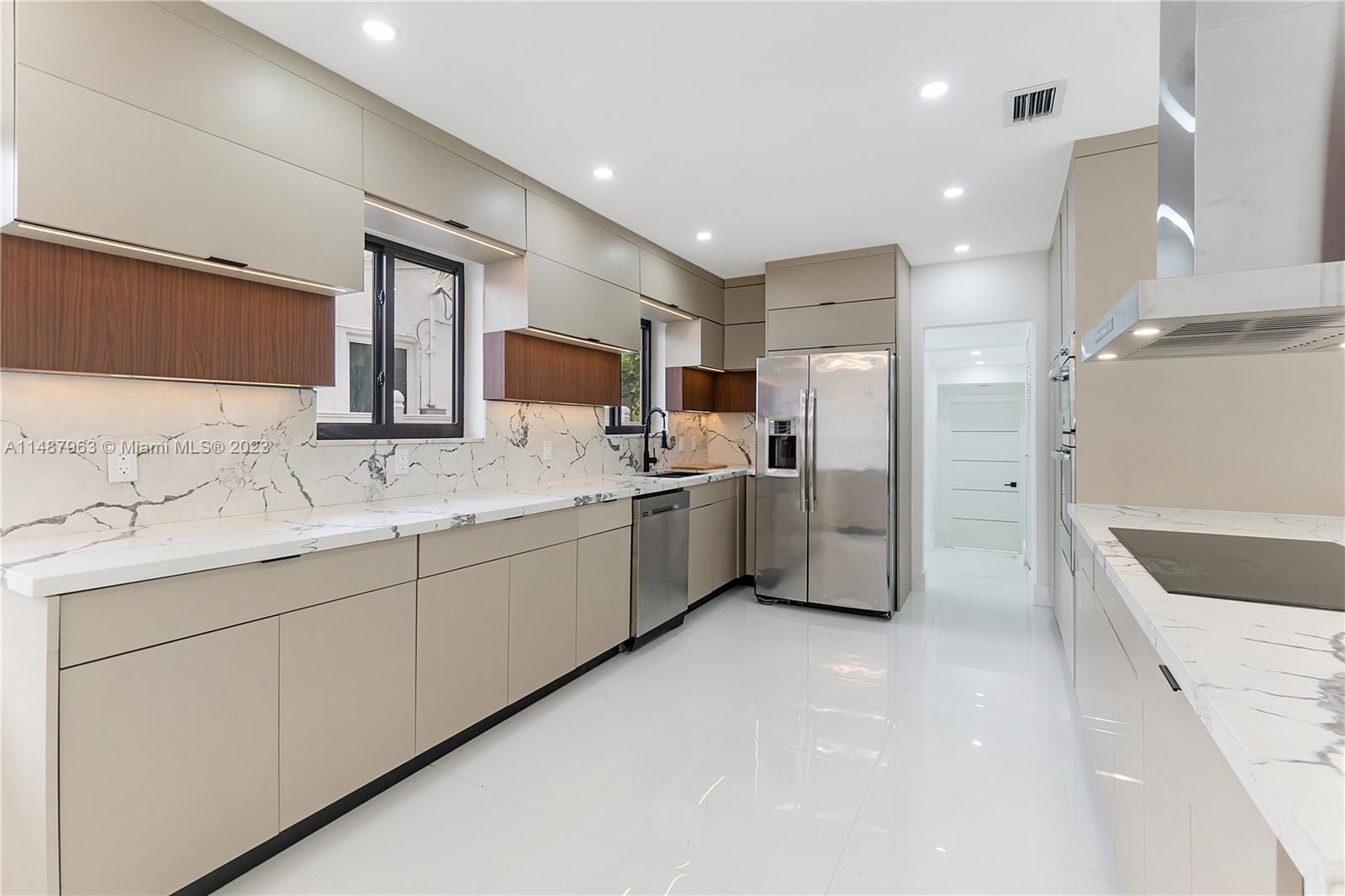 1200 Cleveland Road Miami Beach, FL 33141 - Photo 13 of 41 a large white kitchen with a sink stainless steel appliances and cabinets
