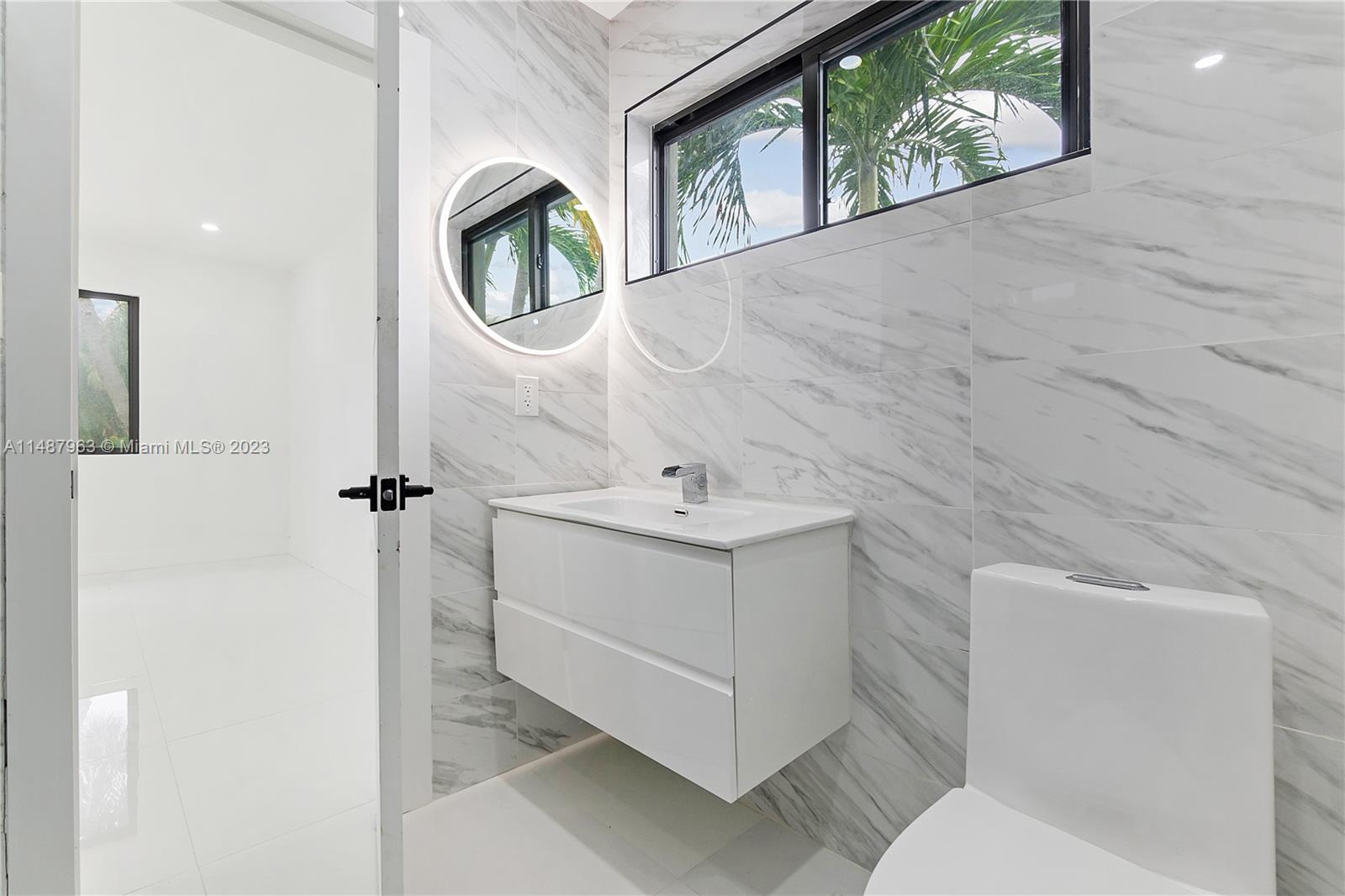 1200 Cleveland Road Miami Beach, FL 33141 - Photo 29 of 41 a bathroom with a toilet sink and mirror