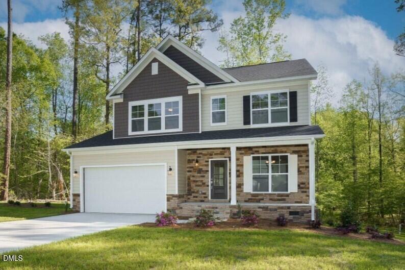 4921 Theater Way Raleigh, NC 27604 - Photo 1 of 26 a front view of a house with a yard and garage