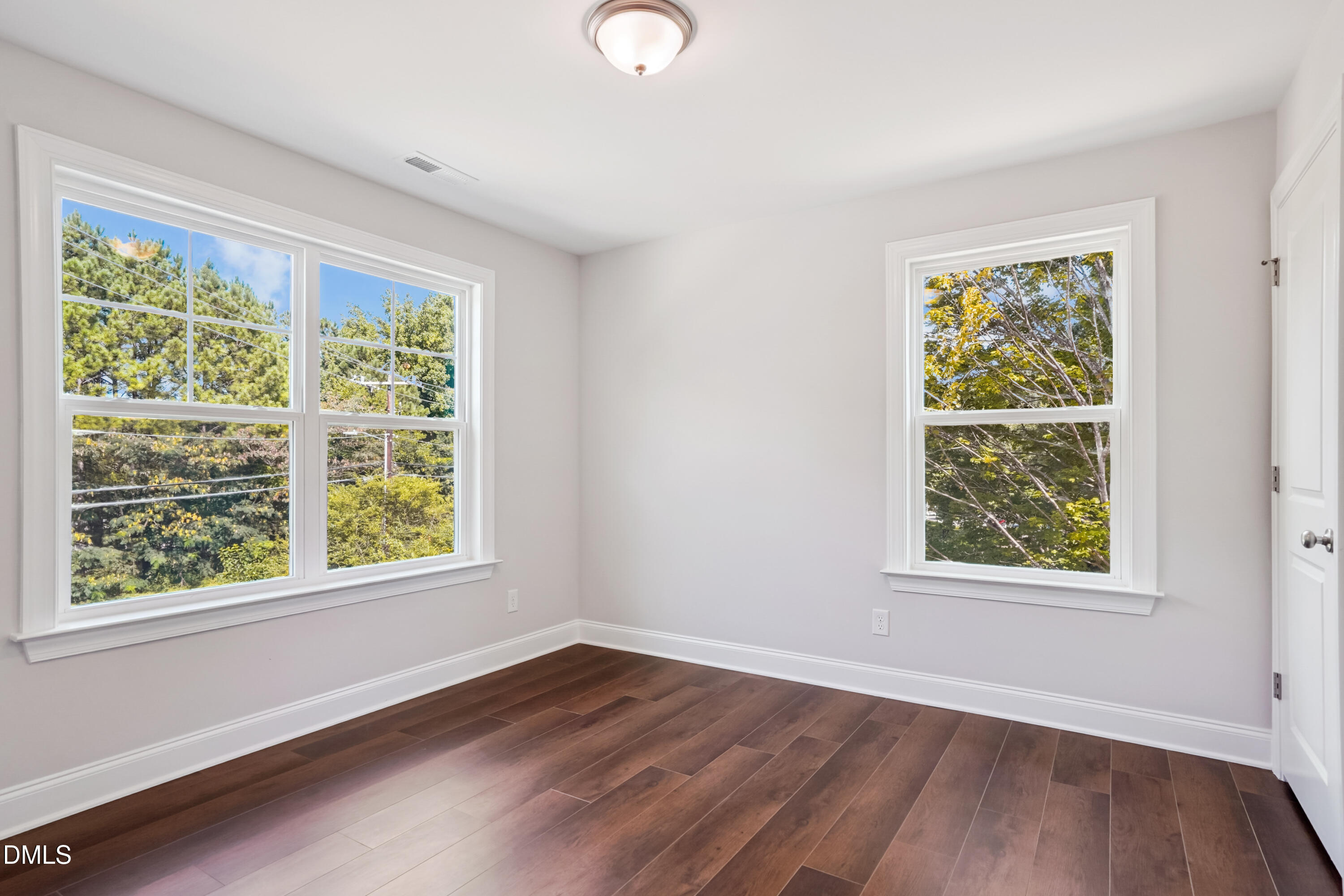 4921 Theater Way Raleigh, NC 27604 - Photo 11 of 26 a view of an empty room with wooden floor and a window