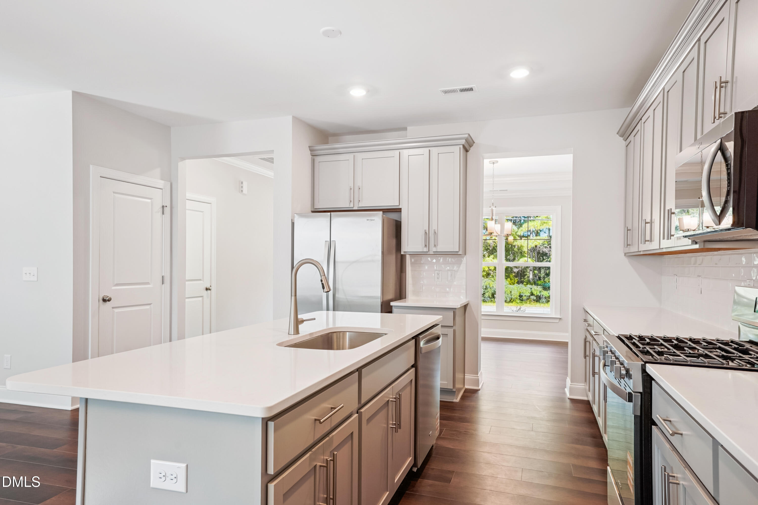 4921 Theater Way Raleigh, NC 27604 - Photo 16 of 26 a kitchen with a sink a stove a refrigerator and a refrigerator