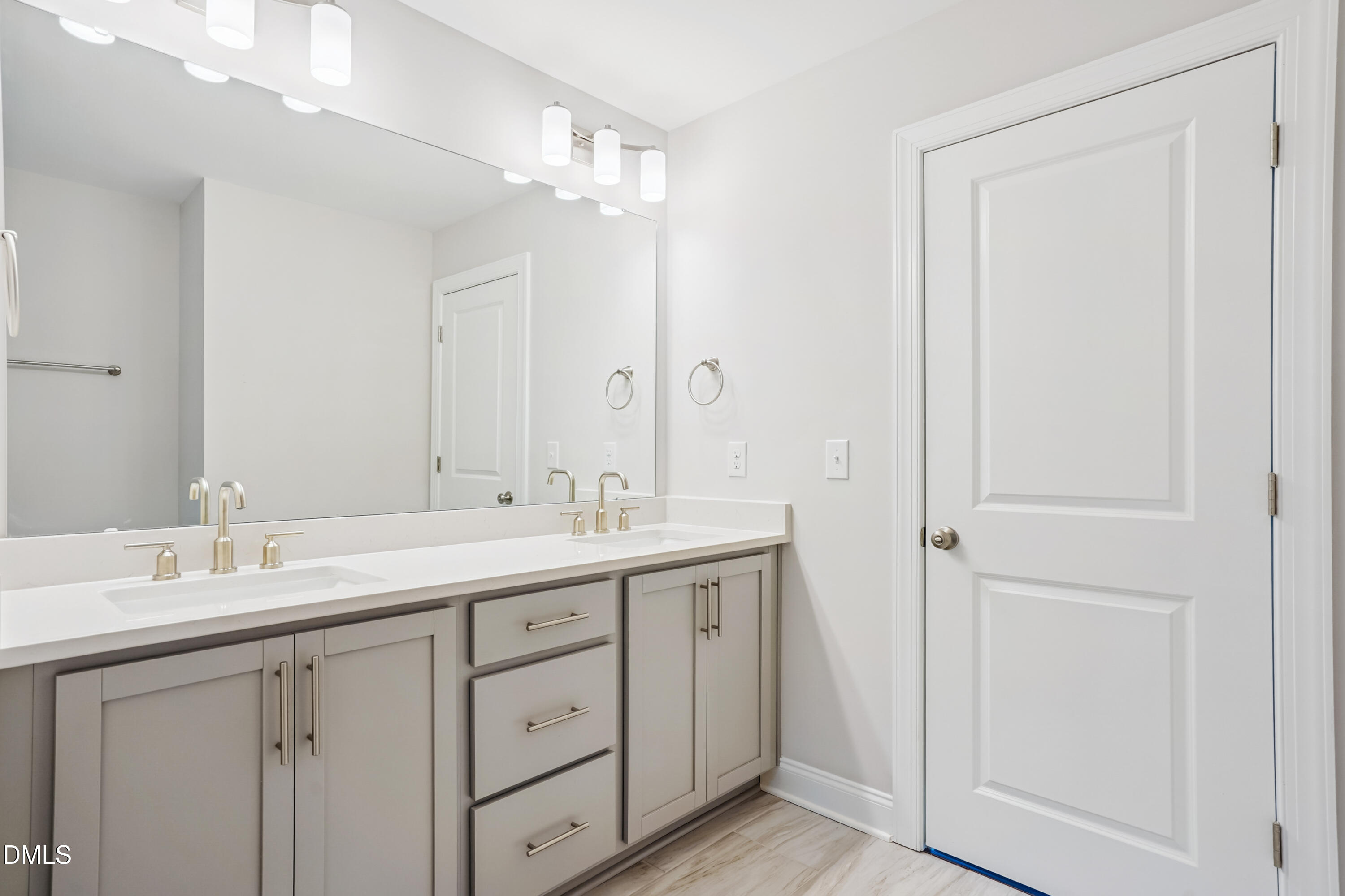 4921 Theater Way Raleigh, NC 27604 - Photo 23 of 26 a bathroom with a double vanity sink and mirror