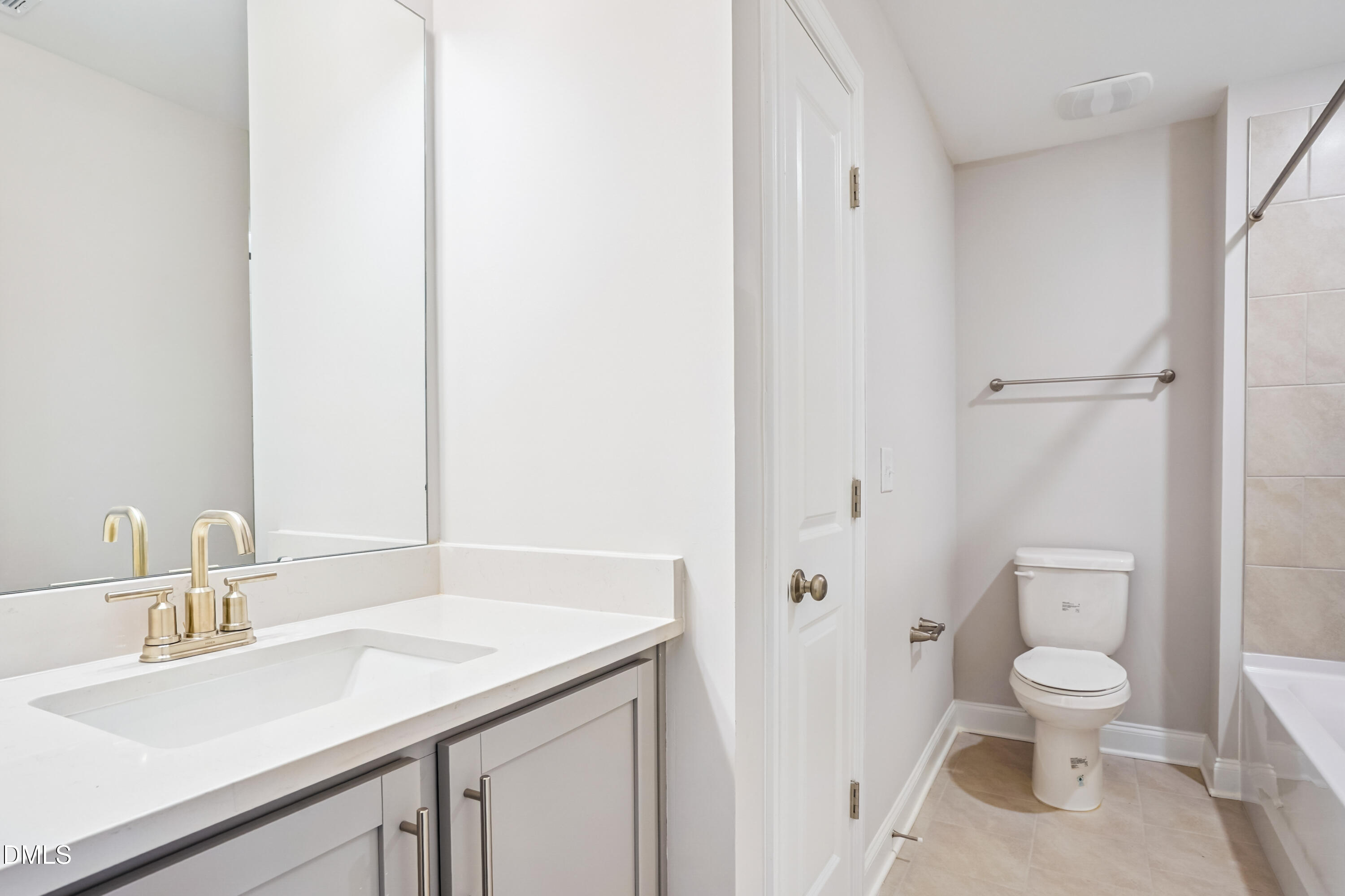 4921 Theater Way Raleigh, NC 27604 - Photo 4 of 26 a bathroom with a sink a toilet and a large mirror