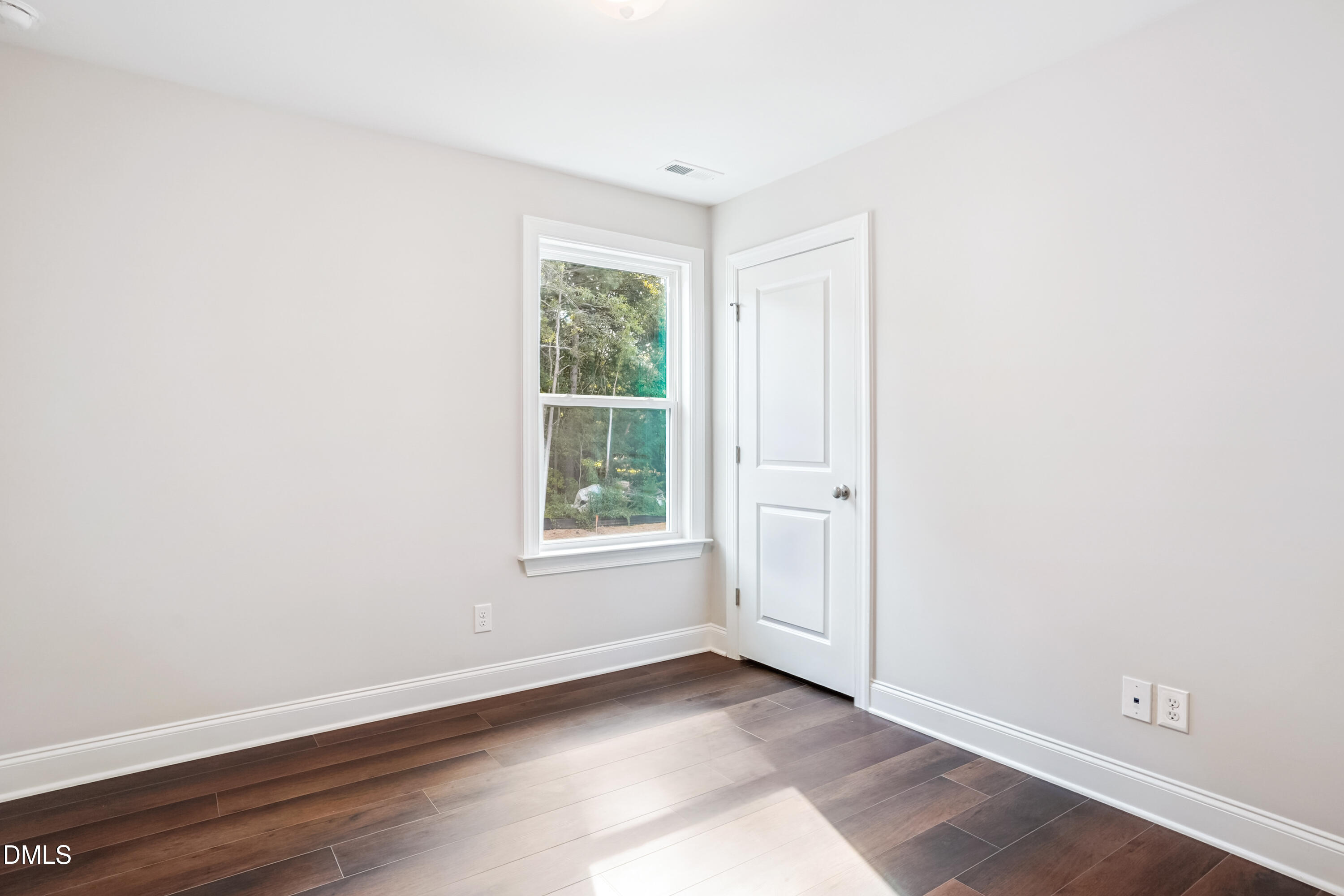 4921 Theater Way Raleigh, NC 27604 - Photo 7 of 26 an empty room with wooden floor and windows