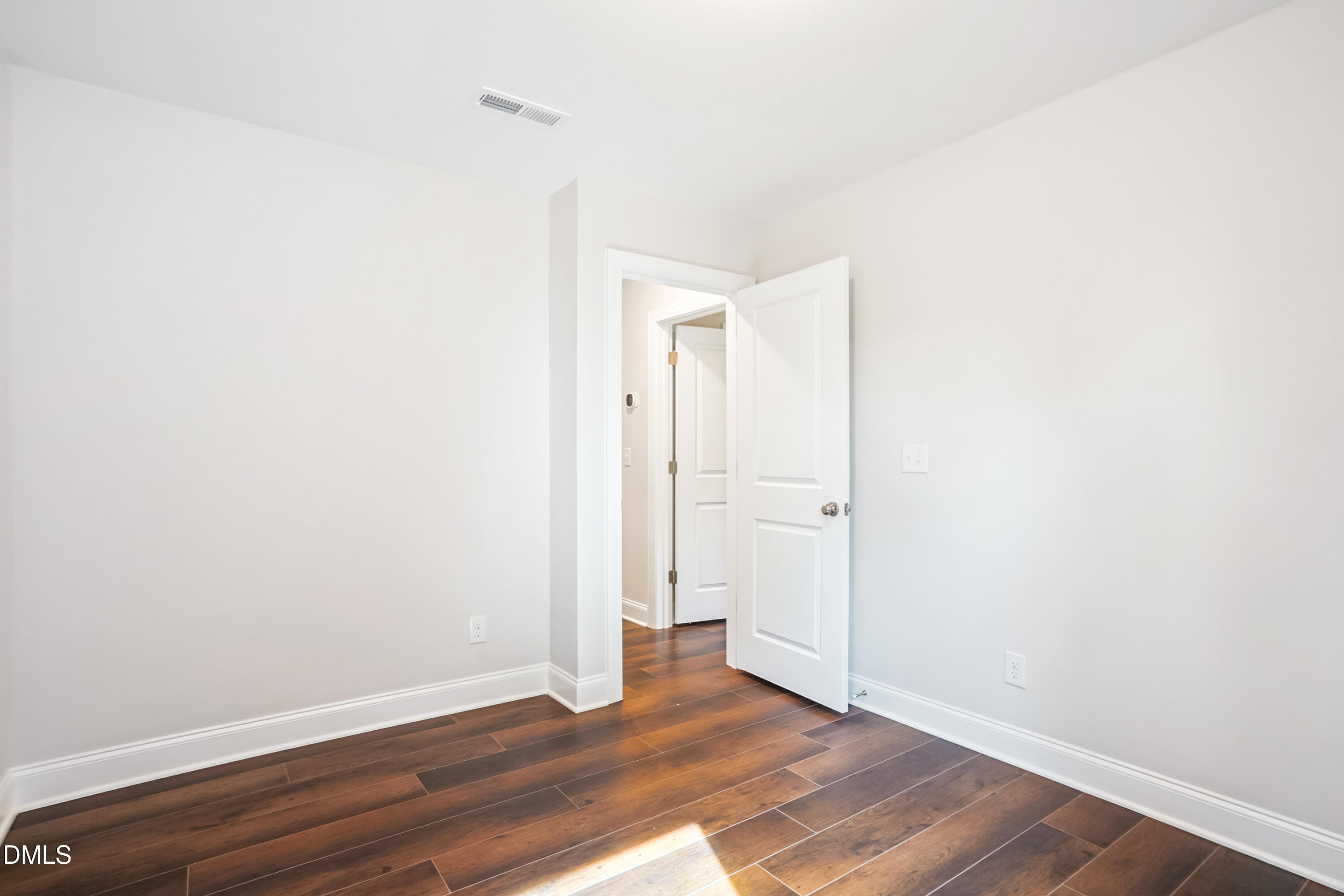 4921 Theater Way Raleigh, NC 27604 - Photo 8 of 26 a view of an empty room with wooden floor