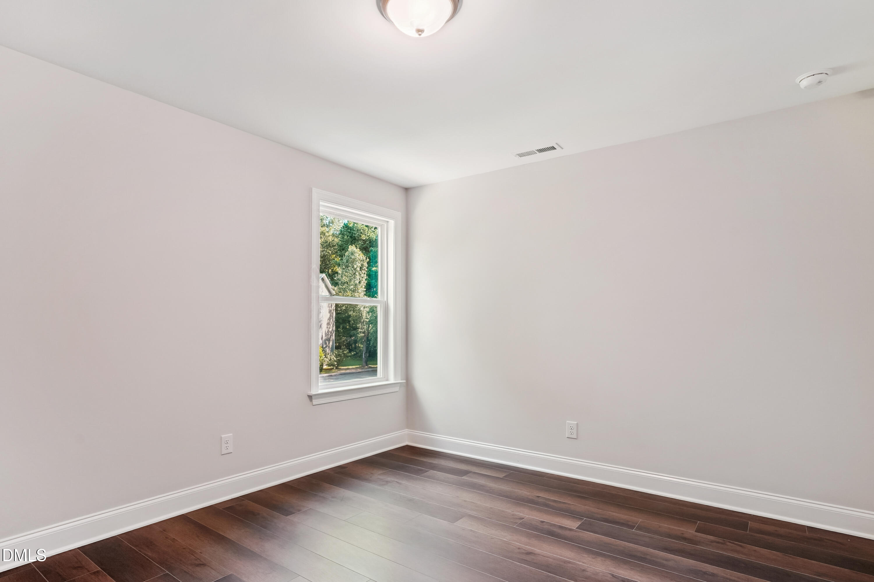 4921 Theater Way Raleigh, NC 27604 - Photo 9 of 26 a view of an empty room with wooden floor and a window