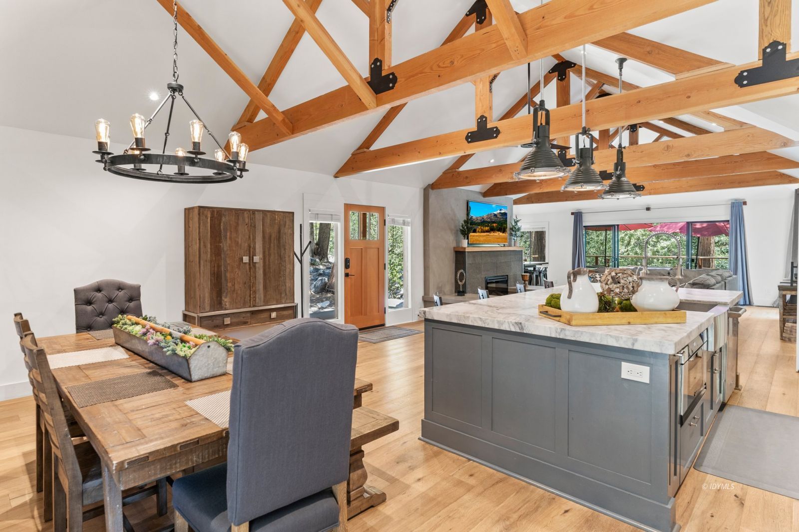 25010 Tahquitz Road Idyllwild, CA 92549 - Photo 12 of 93 a view of a dining room with furniture a chandelier and wooden floor