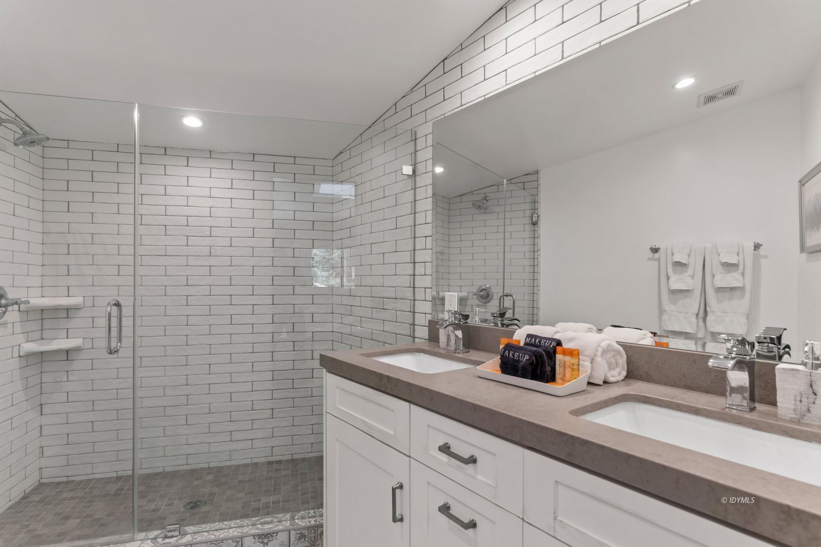 25010 Tahquitz Road Idyllwild, CA 92549 - Photo 24 of 93 a bathroom with a double vanity sink a mirror and shower