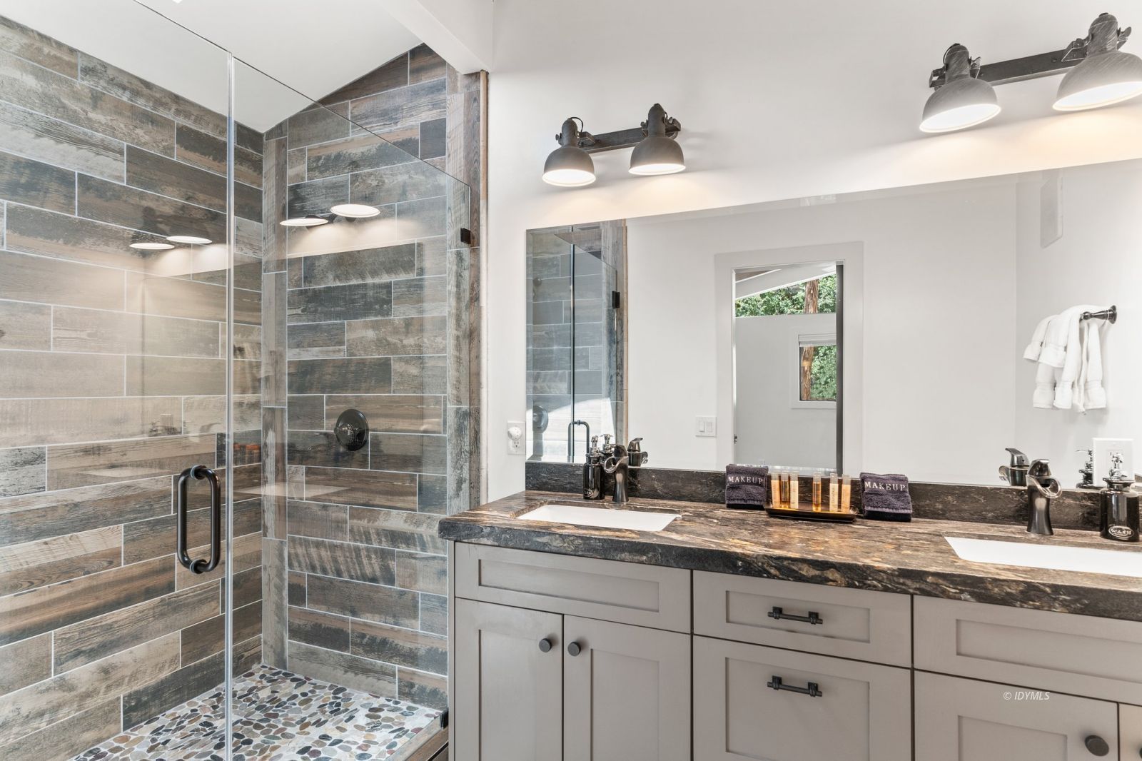 25010 Tahquitz Road Idyllwild, CA 92549 - Photo 35 of 93 a bathroom with a granite countertop sink a mirror and shower