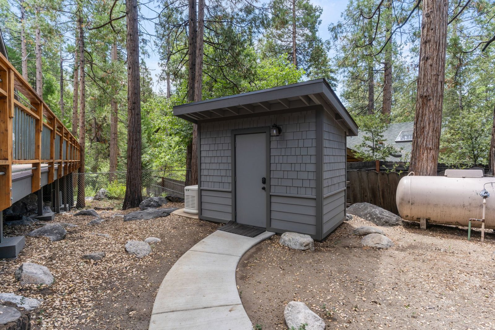25010 Tahquitz Road Idyllwild, CA 92549 - Photo 51 of 93 a backyard of a house with a large tree and wooden fence