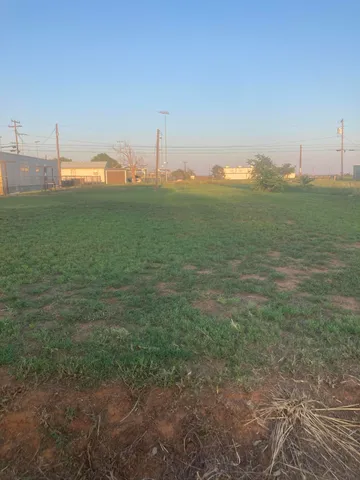 a view of a house with a yard and a garage