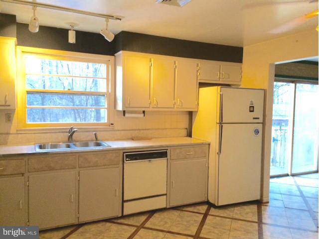 20811 Evergreen Mills Road Leesburg, VA 20175 - Photo 7 of 13 a kitchen with a sink a refrigerator and window