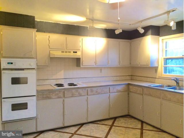 20811 Evergreen Mills Road Leesburg, VA 20175 - Photo 8 of 13 a kitchen with a sink cabinets and window