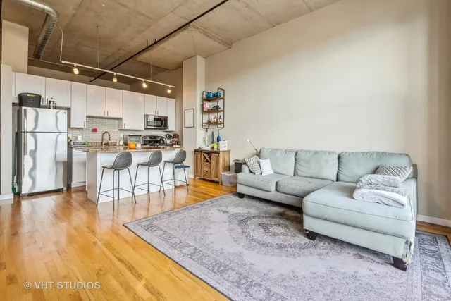 a living room with furniture and a kitchen view
