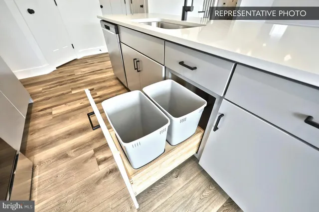 a view of kitchen with sink and wooden floor