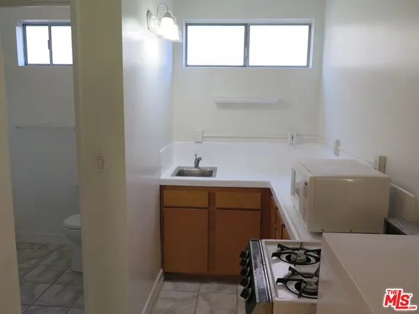 a utility room with a sink dryer and washer