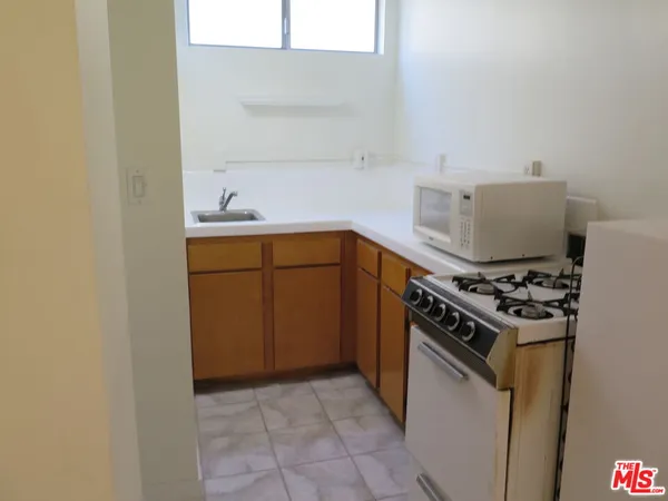a kitchen with a stove and a sink