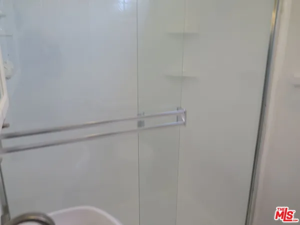 a white toilet sitting next to a shower